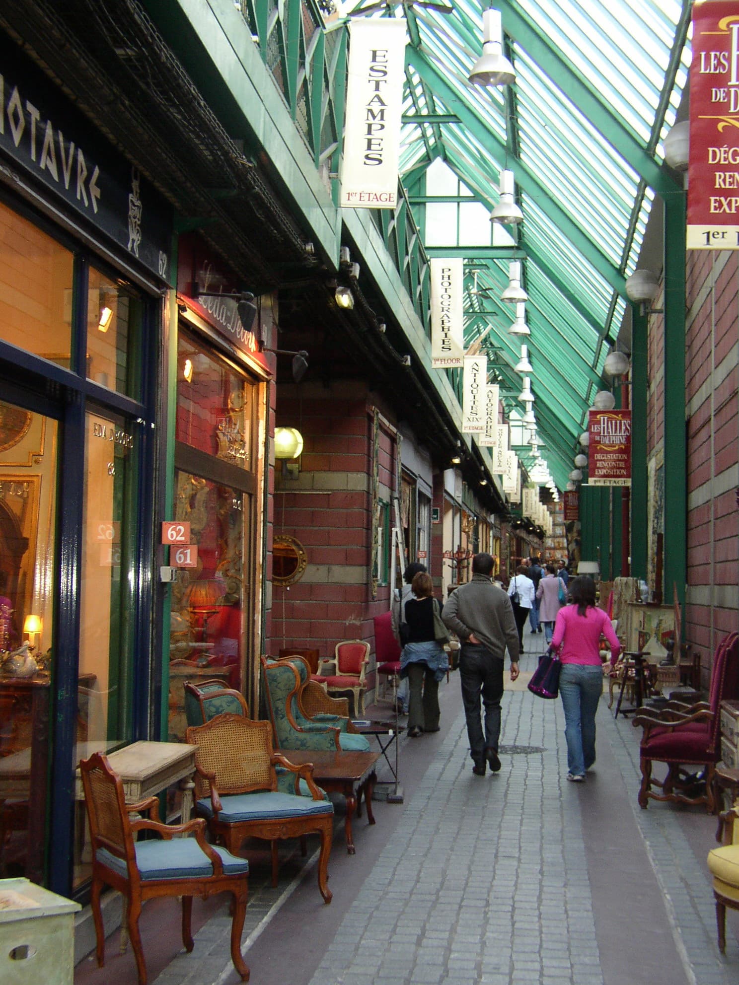 Inomhusloppmarknad med klädstänger och säljarbås i Marché Dauphine, Saint-Ouen.